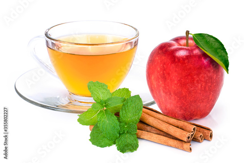 Closeup cup glass of apple cider tea , fresh ripe red washington apple fruit and cinnamon stick with mint green leaf isolated on white background. 