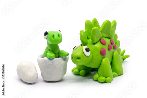 Play dough Stegosaurus and egg on white . Handmade clay plasticine photo