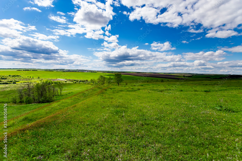 Green hills against the blue sky with clouds. Green hills against the blue sky with clouds.