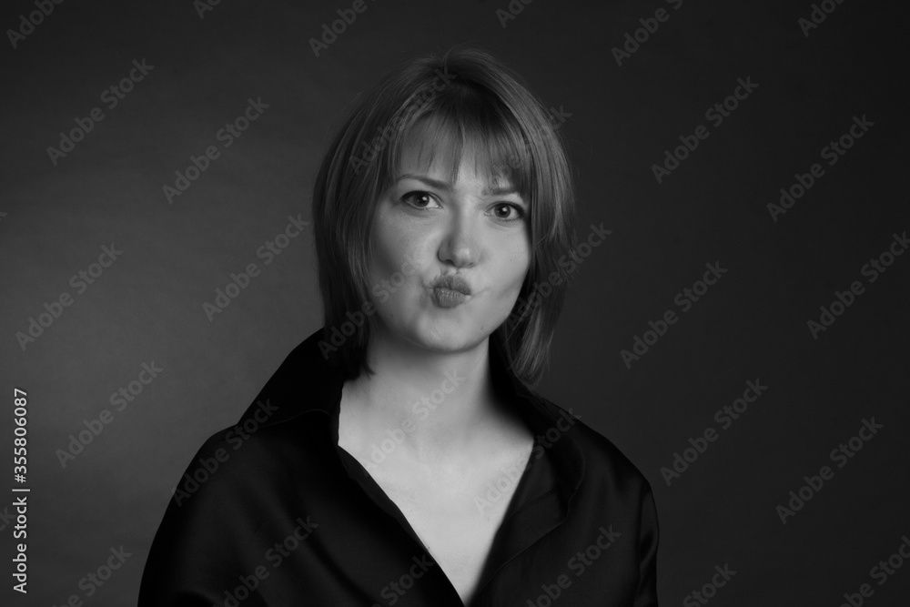 Fototapeta premium black and white Studio portrait of a young woman with short hair in a black blouse