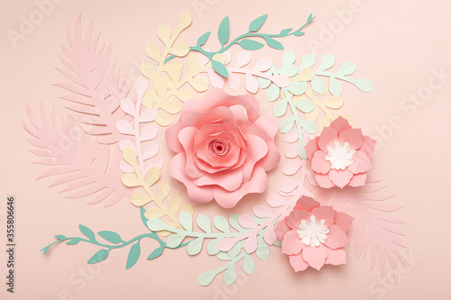Paper art pink background with flowers and tropical leaves. Fashion floral gr...
