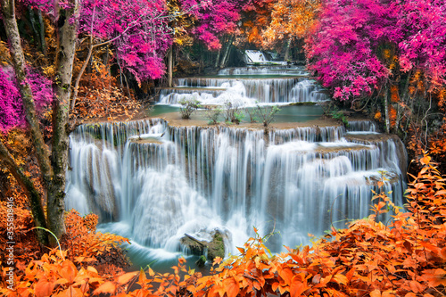 Beauty in nature  beautiful waterfall flowing of water with turquoise color of water in colorful autumn forest at fall season