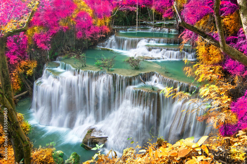 Fototapeta Naklejka Na Ścianę i Meble -  Beauty in nature, beautiful waterfall flowing of water with turquoise color of water in colorful autumn forest at fall season