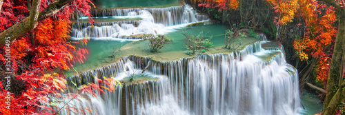 Fototapeta Naklejka Na Ścianę i Meble -  Beauty in nature, beautiful waterfall flowing of water with turquoise color of water in colorful autumn forest at fall season