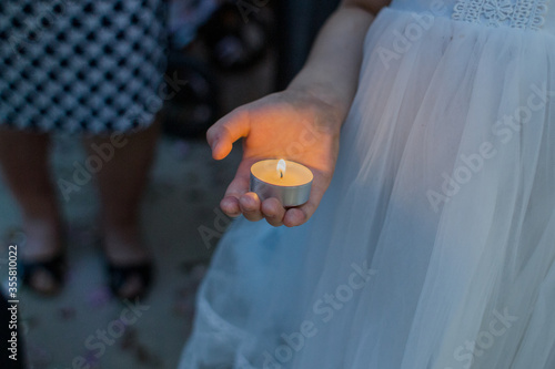 candle in the hand of a child