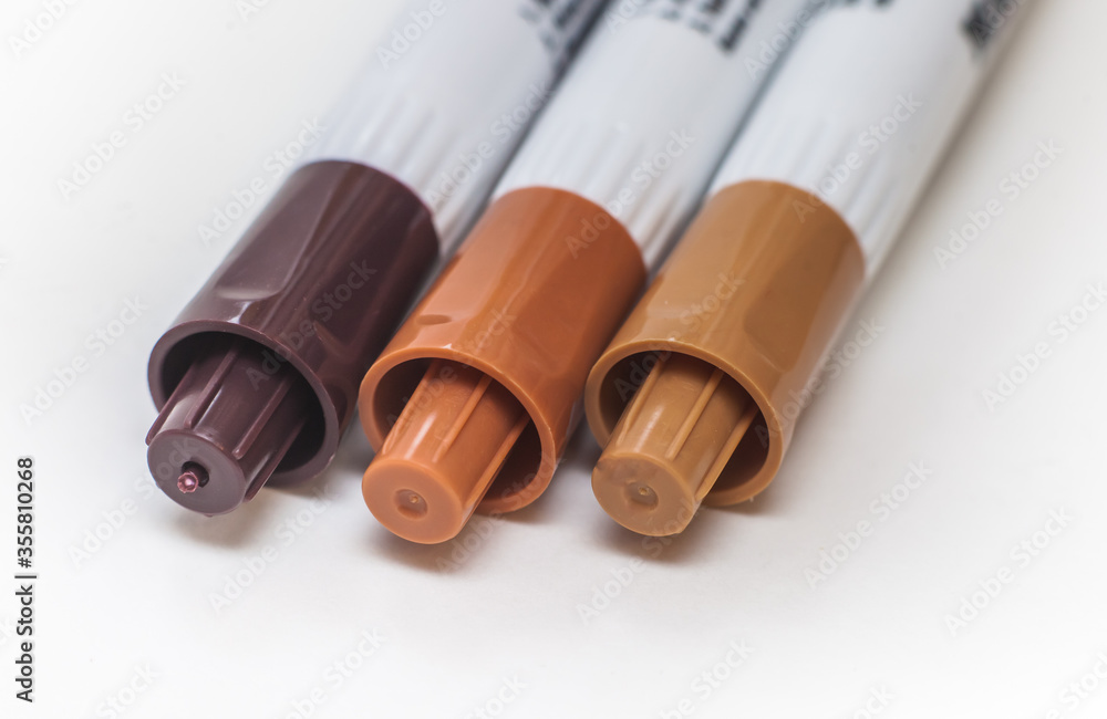 Fototapeta premium A set of brown markers on a white background