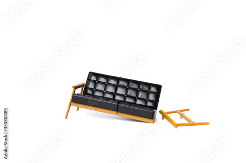 broken black leather sofa with wood leg on white background, broke and fix concept
