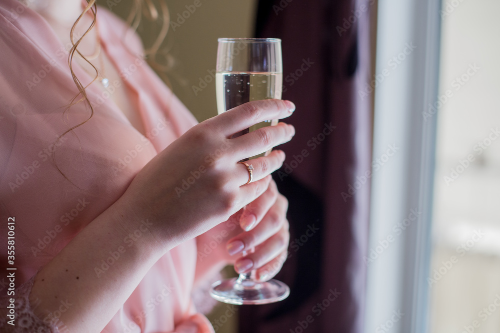 woman in peignoir with a glass of champagne