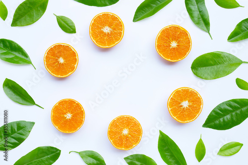 High vitamin C, Juicy and sweet. Frame made of orange fruit with leaves on white background.
