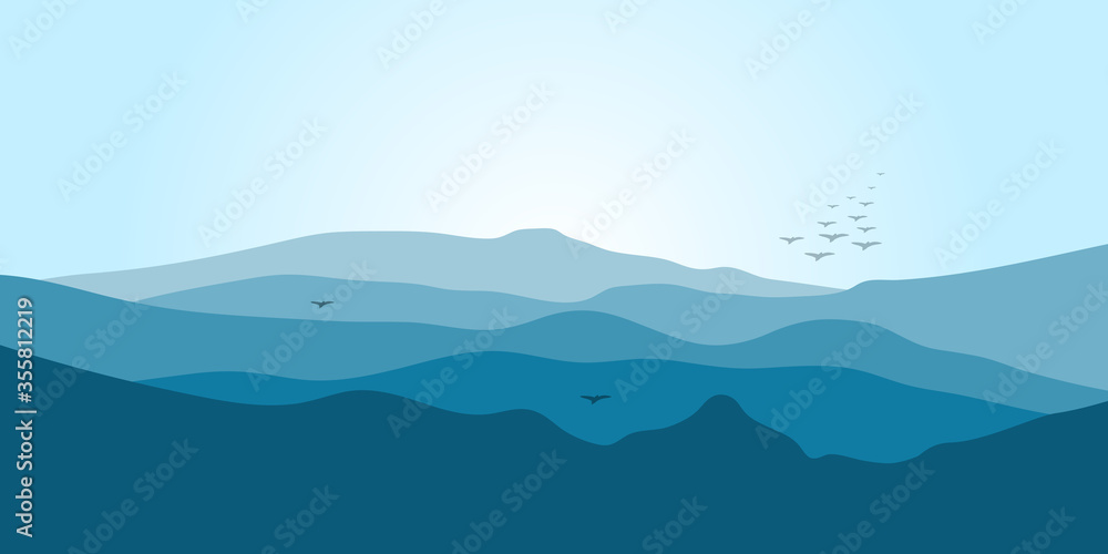 Mountain landscape in blue tones with fog and flying birds.