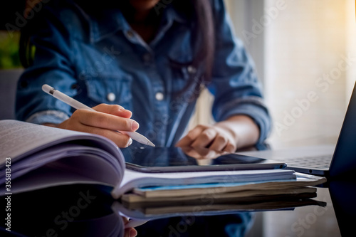 Young teen girl online education by using digital tablet computer at home. Distance learning, home school concept.