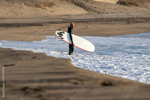 Surfing in Japan, man riding a surfboard in the pacific ocean near Tokyo photo