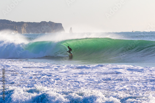 Photography Surfing in Japan, man riding a surfboard in the pacific ocean near Tokyo