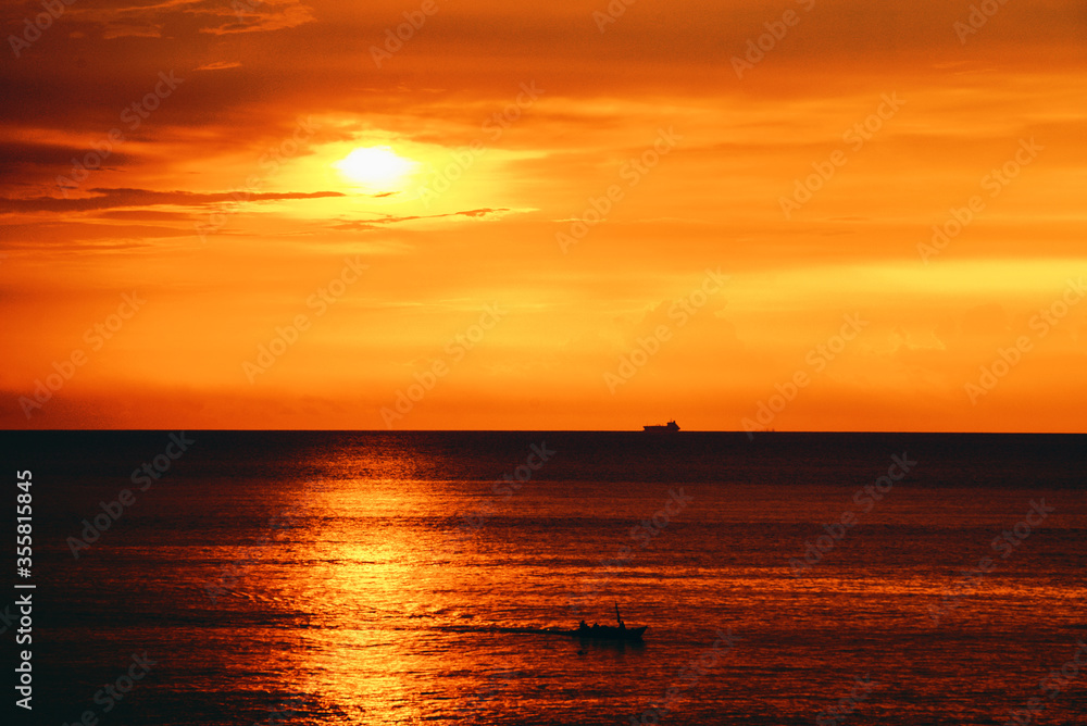 Silhouette boat in the ocean at sunset