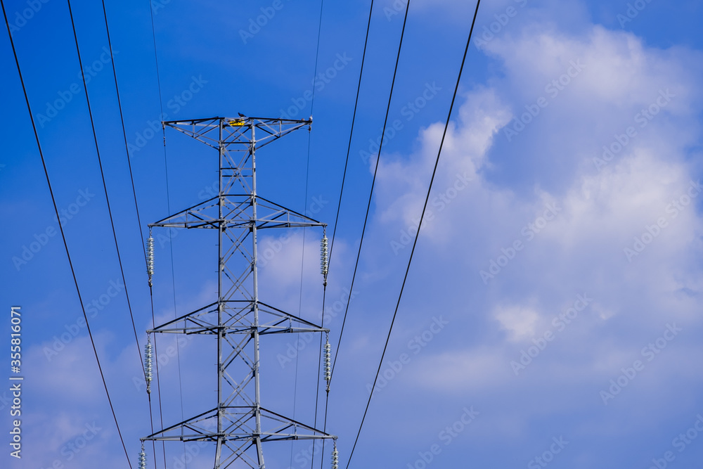 Electrical tower station wiring power with cloudy and blue sky background, High voltage station post Electrical tower station wiring power with cloudy and blue sky background, High voltage station post