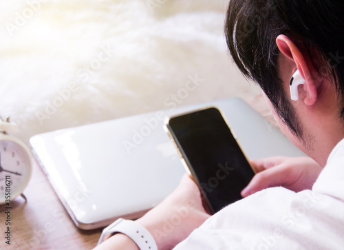 Man with wireless earpiece.