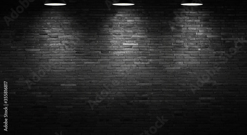 The black wall surface uses a lot of bricks. or old black brick wall abstract pattern. Put together beautifully dark background. photo
