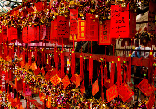 Close up of  red chinese prayer tags hanging in a temple photo