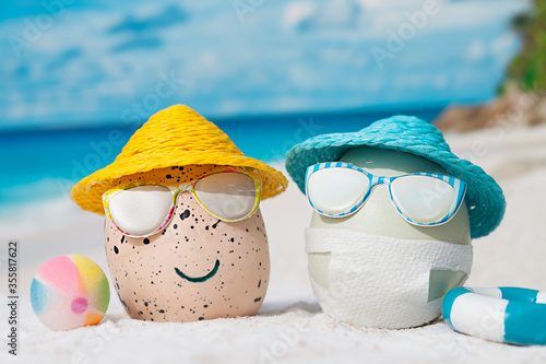 Easter eggs on beach on isolation. One egg wearing facial mask