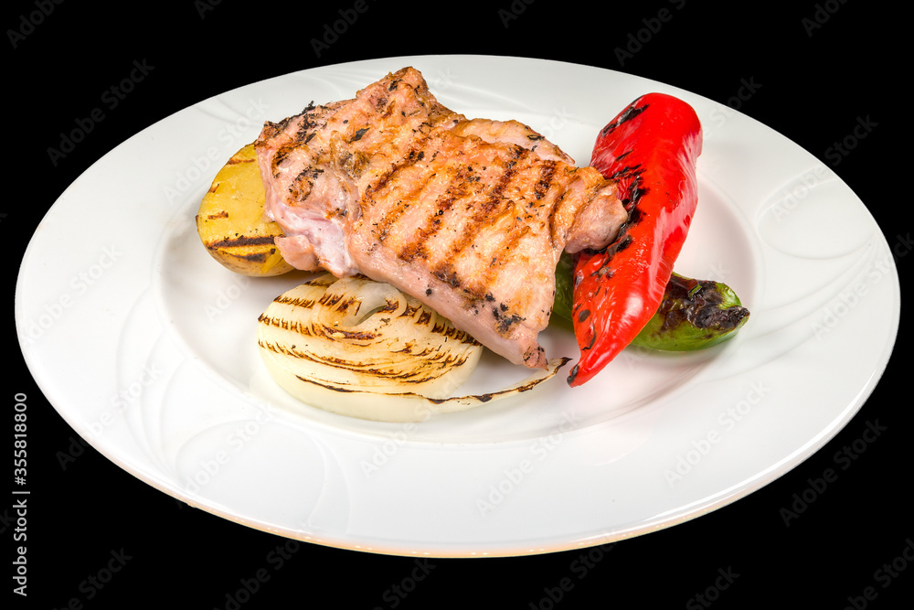 Delicious chicken steak with grilled vegetables on a white plate, isolated on black background Delicious chicken steak with grilled vegetables on a white plate, isolated on black background