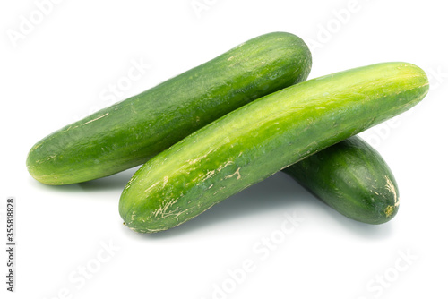 Three cucumbers on an isolated white background