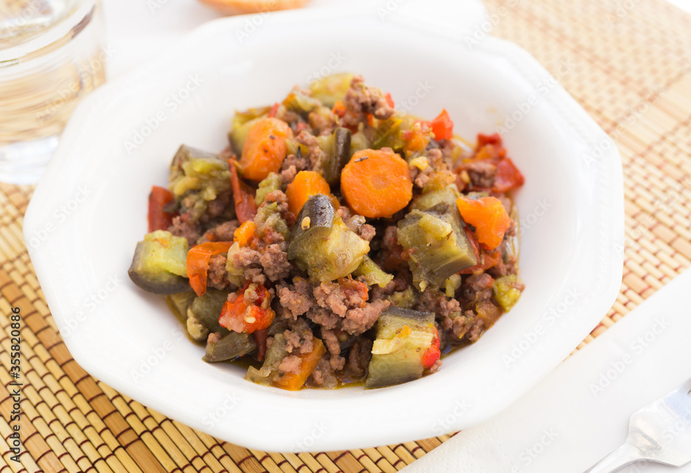 dish of vegetable stew. stewed eggplant, minced meat, carrots, peppers, onion squid