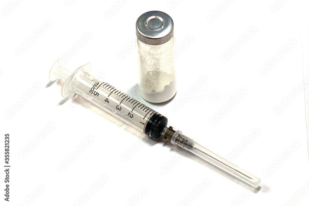 syringe and ampoule with medicine on the white background syringe and ampoule with medicine on the white background