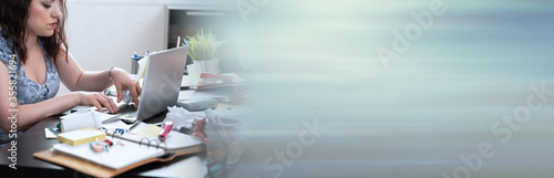 Businesswoman working on a messy desk  panoramic banner