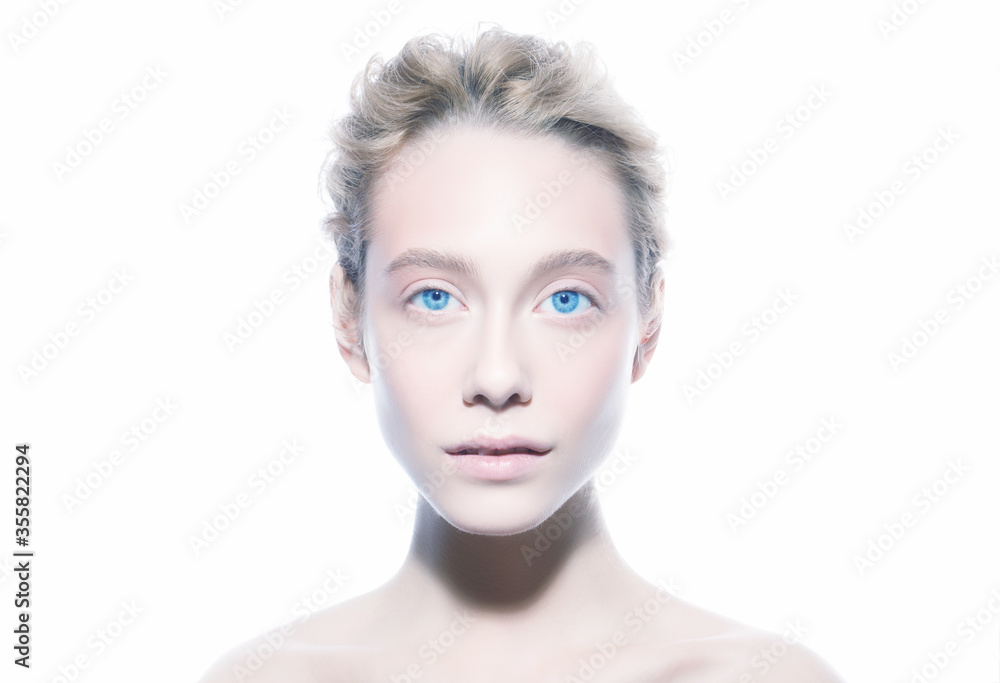 Beauty fashion portrait of young woman face with blue eyes and blond hair looking at camera, isolated on white background. Skin care or cosmetic ads