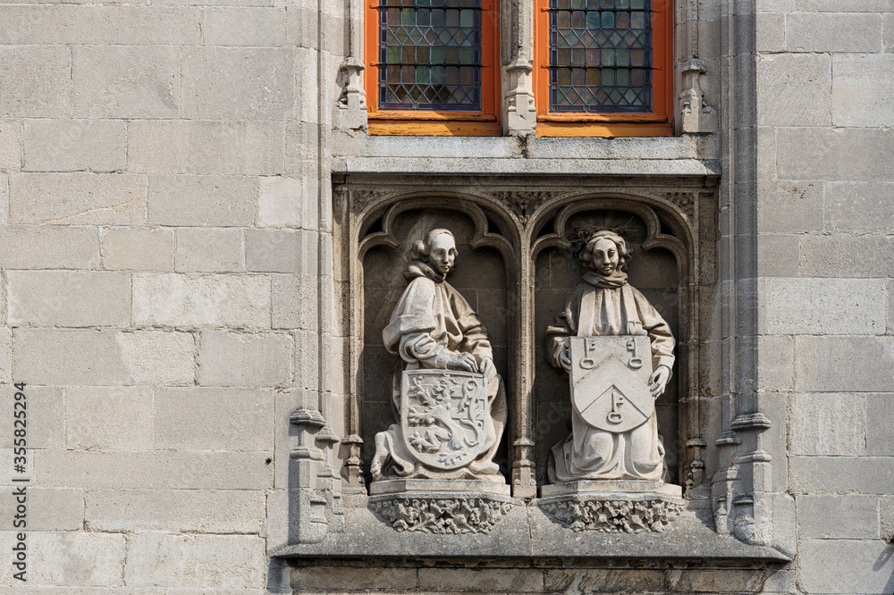statue on a facade of the Poortersloge, in Bruges, Belgium
