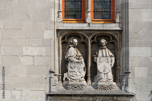 statue on a facade of the Poortersloge, in Bruges, Belgium photo