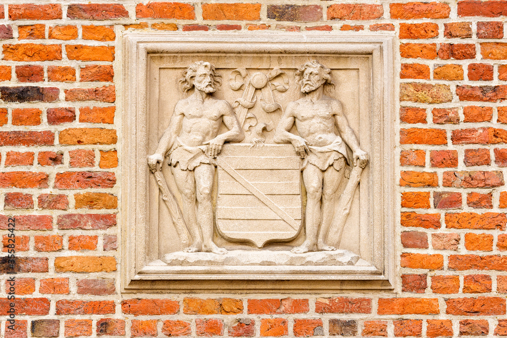 coat of arms on a brick house in Bruges, Belgium