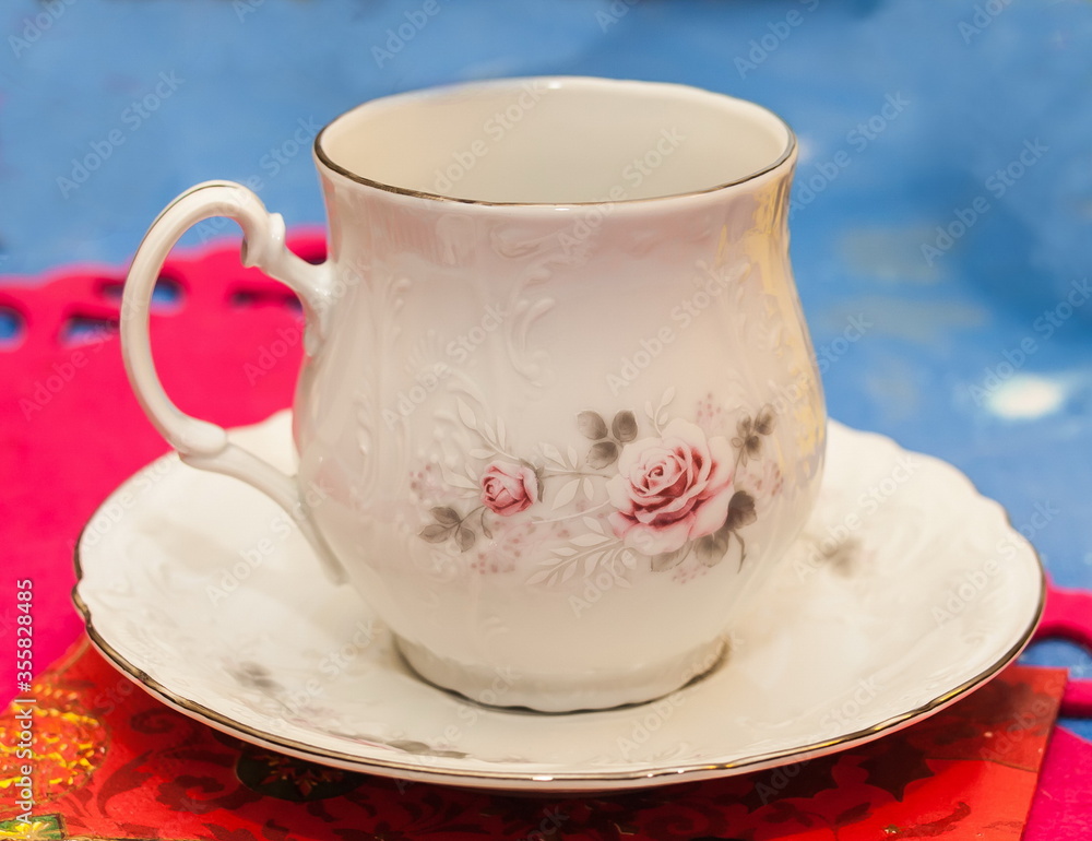 Fototapeta premium Cup saucer for drinks on color napkin, on the table