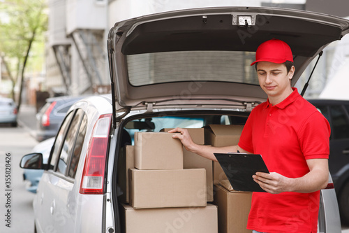 Courier checks parcels and online orders in tablet