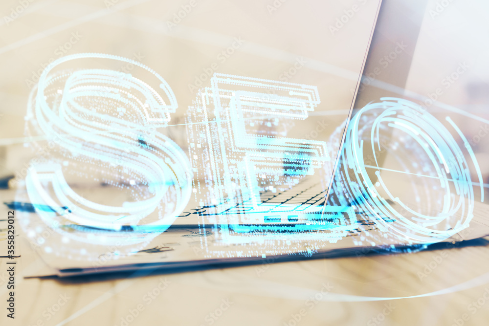 Double exposure of table with computer and seo drawing hologram. Search optimization concept. Double exposure of table with computer and seo drawing hologram. Search optimization concept.