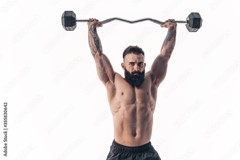 Muscular bodybuilder guy doing exercises with dumbbell over white background. Muscular bodybuilder guy doing exercises with dumbbell over white background.