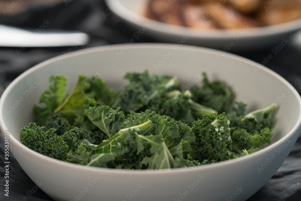 kale salad leaves in white bowl on linen napkin with other ingredients on background kale salad leaves in white bowl on linen napkin with other ingredients on background