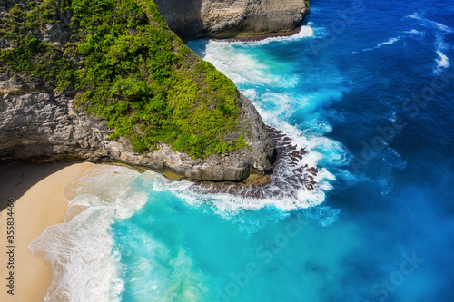 Coast with rocks as a background from top view. Blue water background from top view. Summer seascape from air. Bali island, Indonesia. Travel - image © biletskiyevgeniy.com