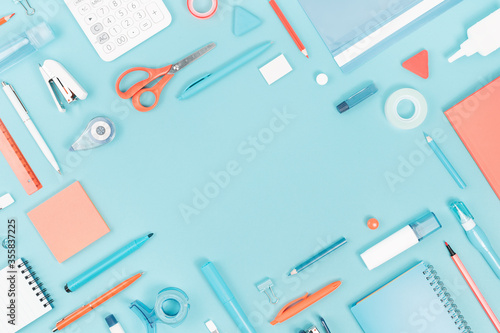Assorted office and school white orange and blue stationery supply on pastel trendy background as knolling. Flat lay with copy space for back to school or education and craft concept.