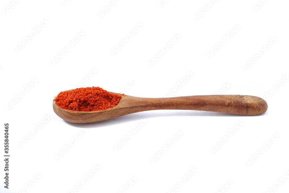 Red chili powder in wooden spoon Red chili powder in wooden spoon