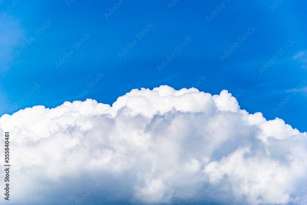 Blue sky with lush white clouds below Blue sky with lush white clouds below