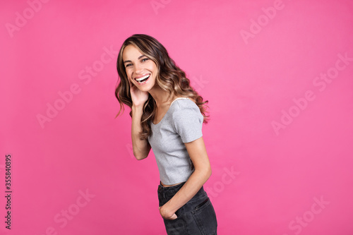 Portrait happy woman on pink background.