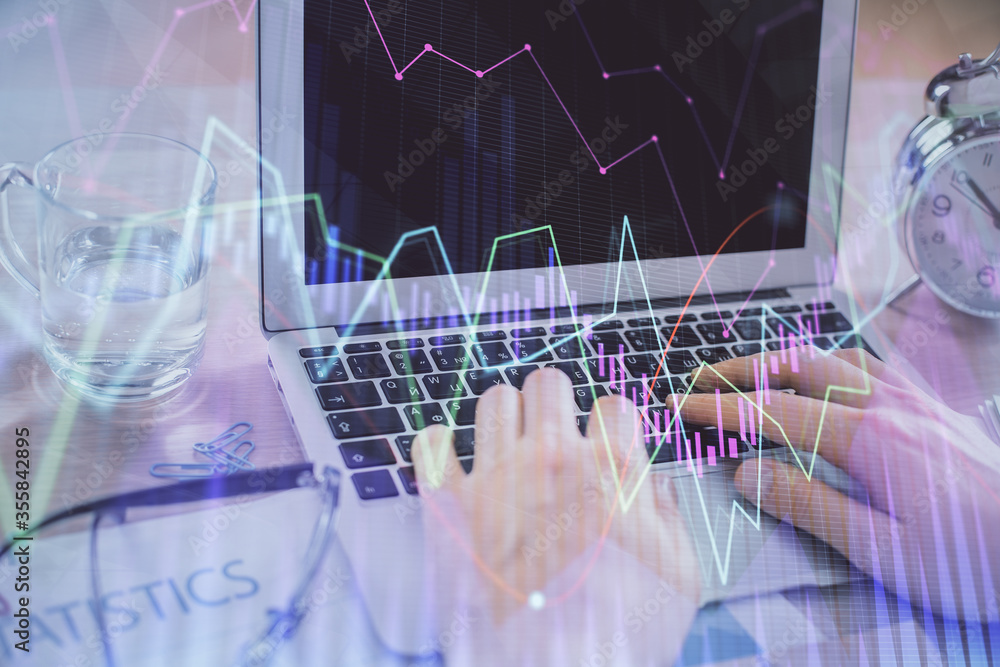 Multi exposure of market chart with man working on computer on background. Concept of financial analysis. Multi exposure of market chart with man working on computer on background. Concept of financial analysis.