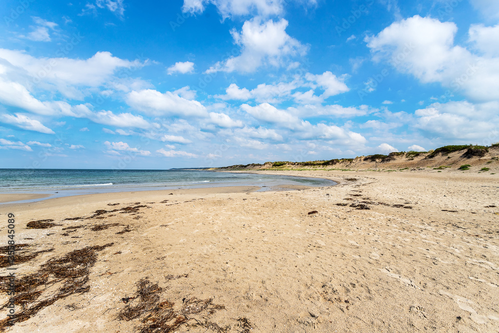 Beautiful seascape with sandy beach and beautiful cloudy sky. Denmark. North Sea. Nature. Relaxation Beautiful seascape with sandy beach and beautiful cloudy sky. Denmark. North Sea. Nature. Relaxation