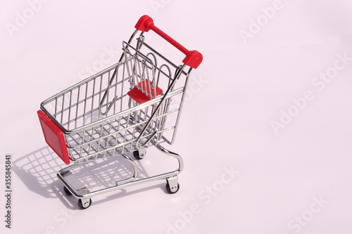Mini supermarket basket on a white background. Sale and online shopping concept. Money saving concept