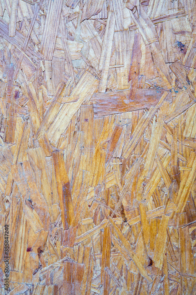 Sheet of plywood with fragments of compressed sawdust.