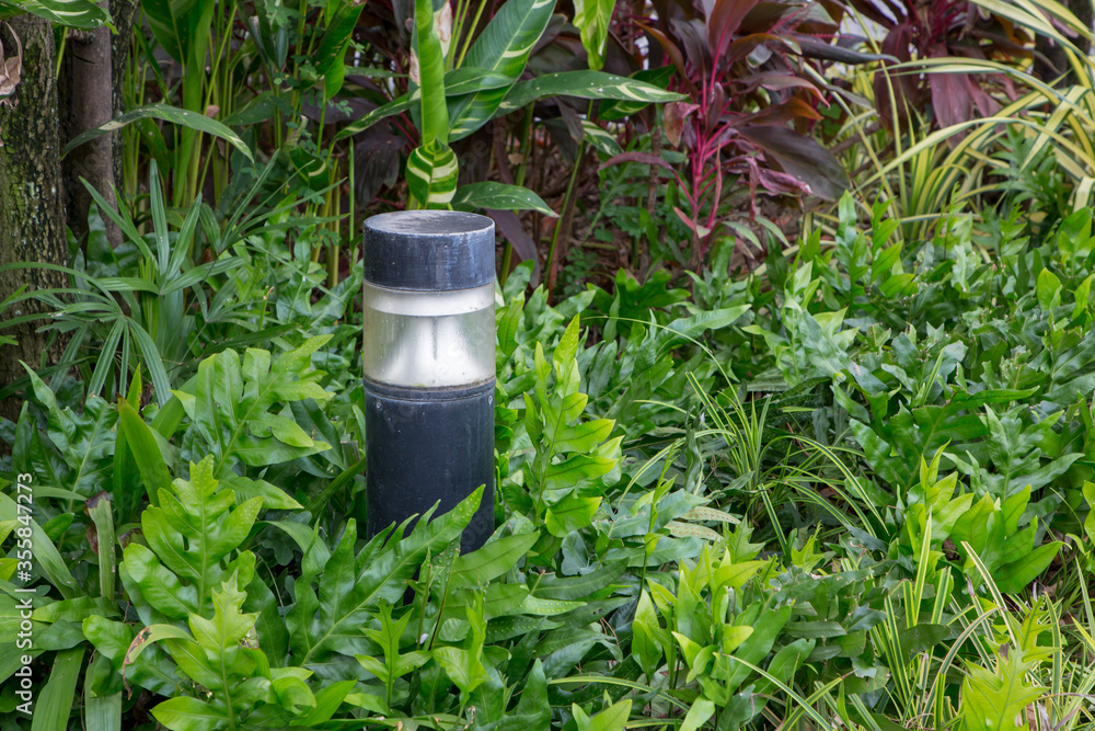 small lantern in a garden on the ground