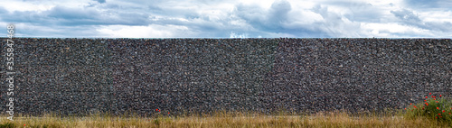 gabion wall made of metal grid filled with gravel photo