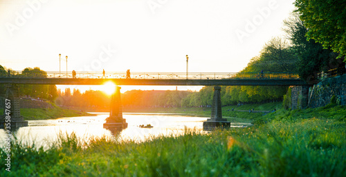 View of bridge on river Uzh at city Uzhgorod, Transcarpathia, Ukraine Europe. Amazing sunset time. photo