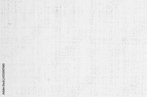 White fabric jute hessian sackcloth canvas woven gauze texture pattern in light white color blank. Natural linen and cotton cloth texture as clean background empty for decoration.